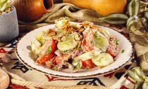 Cucumber-and-tomato-salad-with-walnuts-tomatoes-small-cucumbers-scallion-or-red-onion-garlic-clove-walnuts-green-chopped-pepper-salt